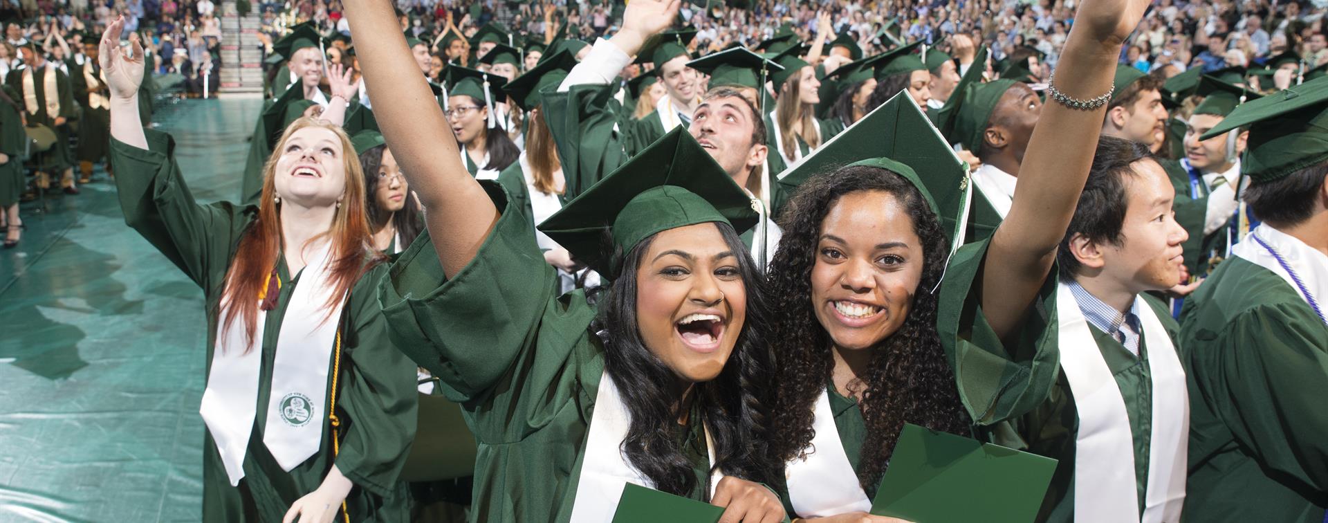 Two students smiling on graduation day