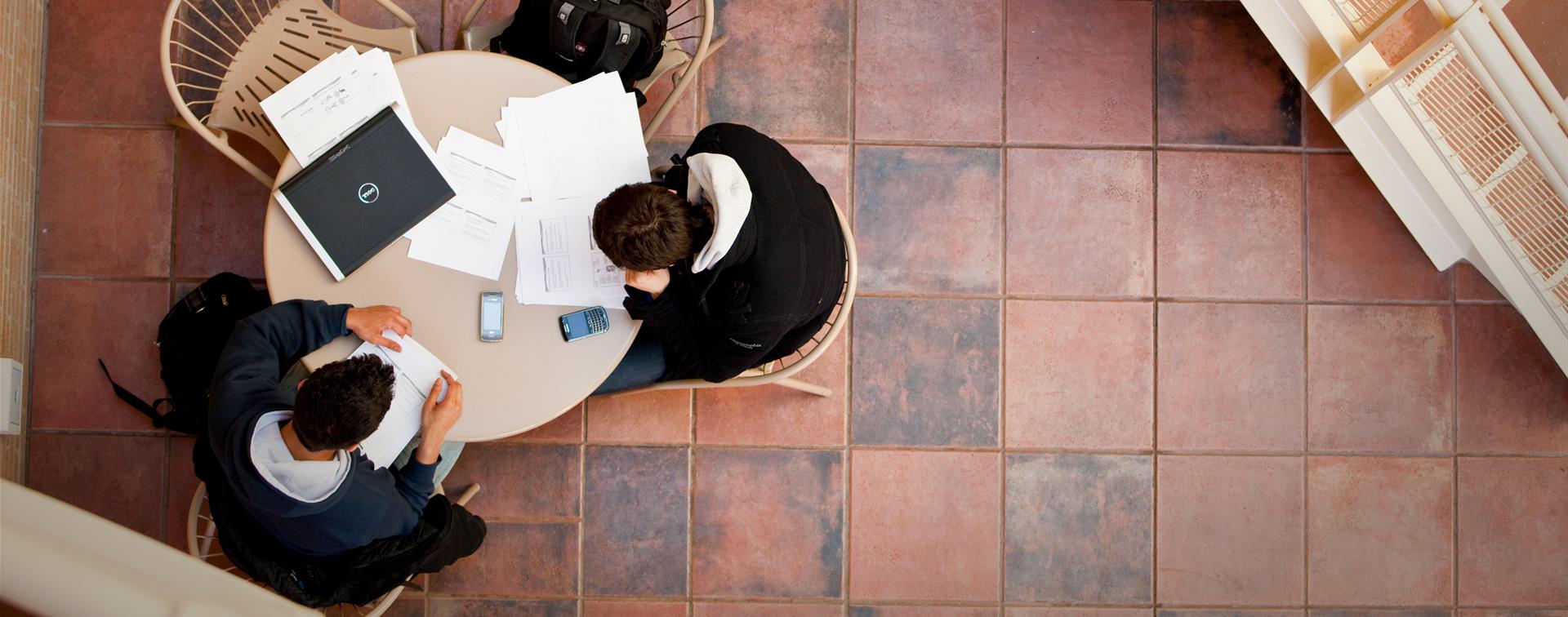 Picture of a group of people working together at a table.