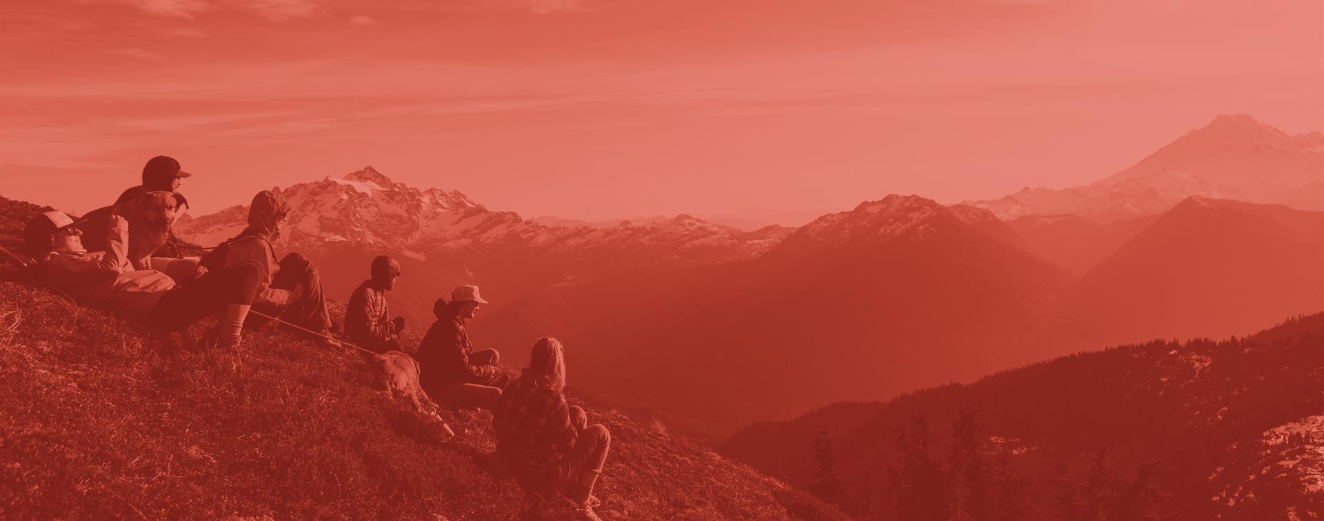 A picture of a group of students sitting on top of a mountain