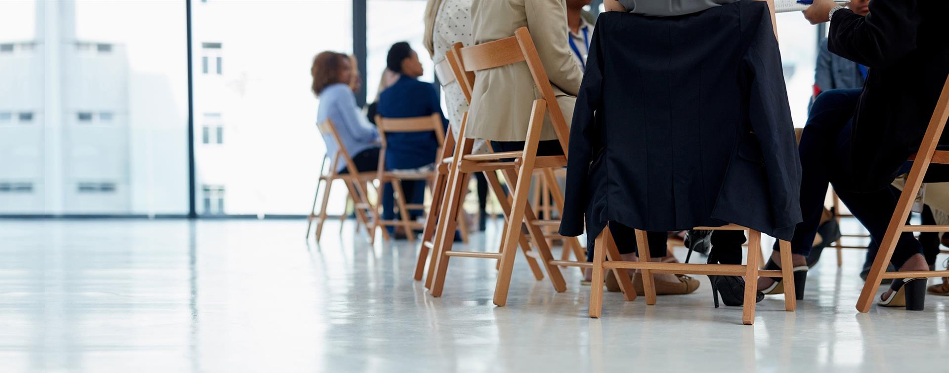 A picture of people sitting in a circle and networking