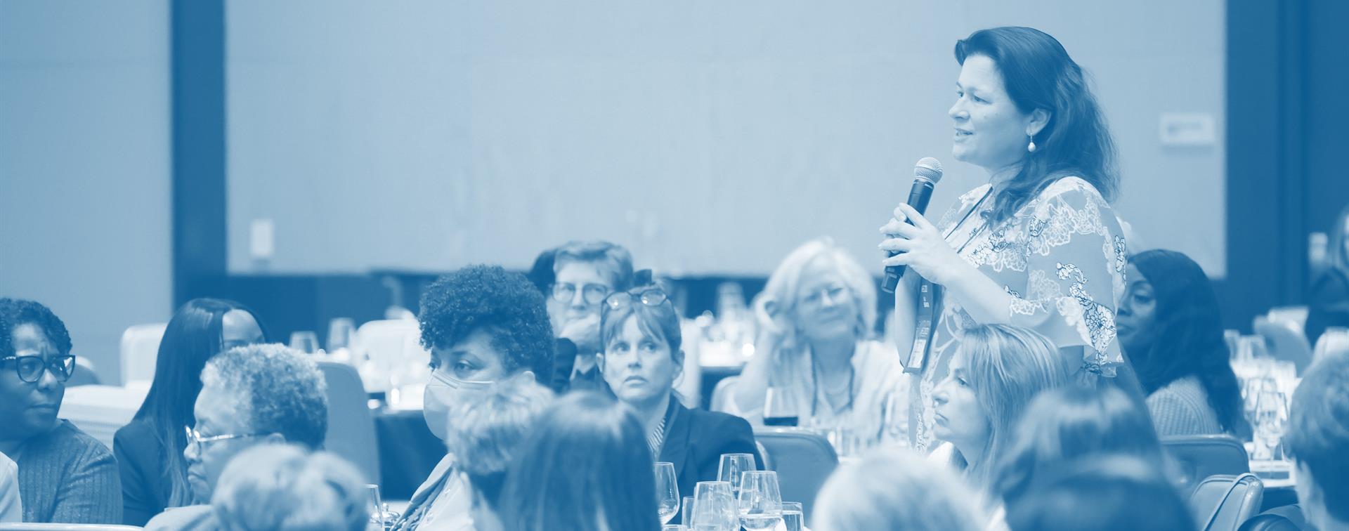 A women speaking at a conference