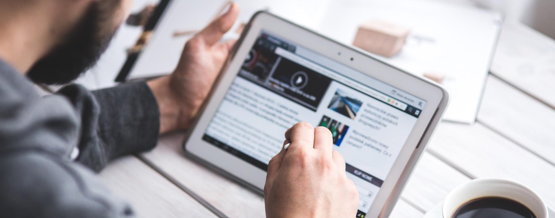 Guy reading on tablet