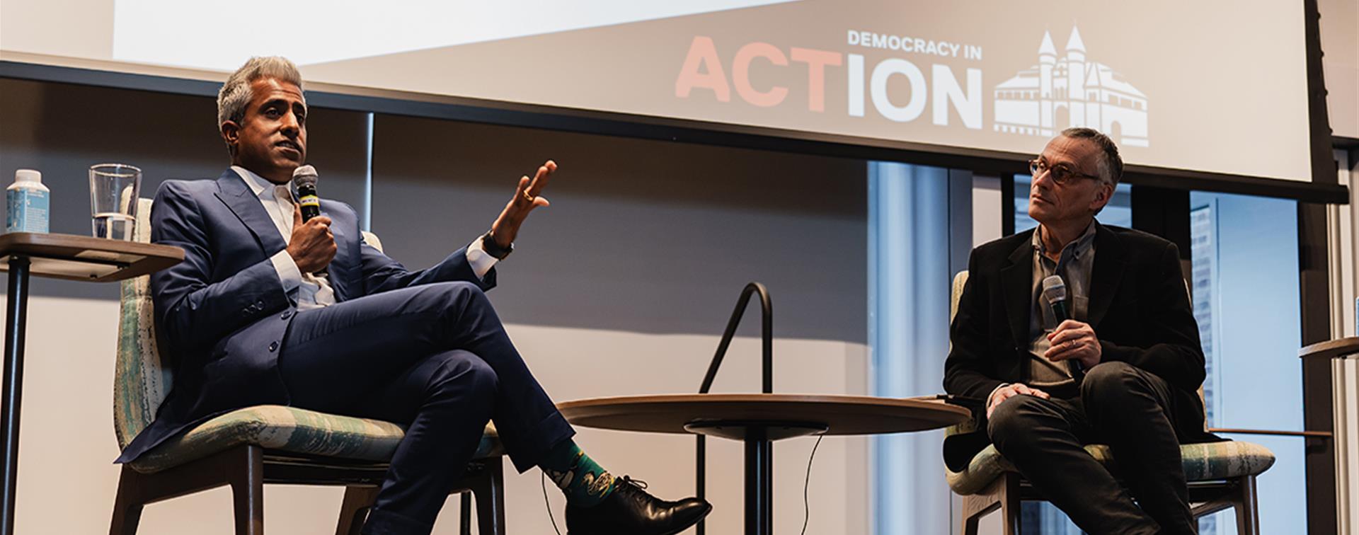 Photo of Anand Giridharadas speaking with Wesleyan President Michael S. Roth 