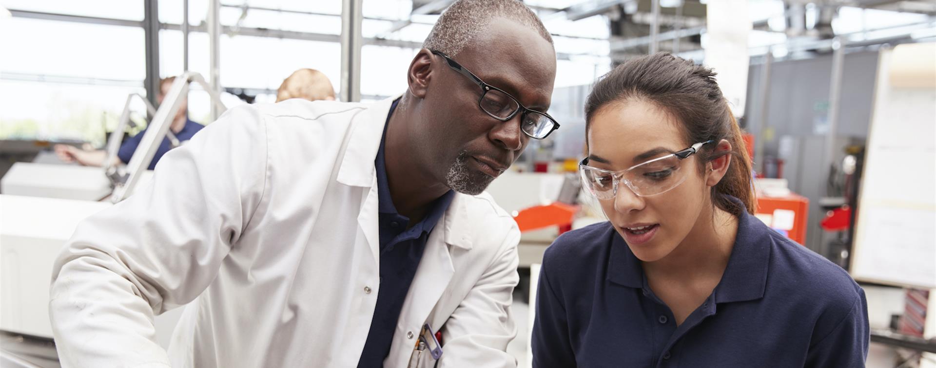 Picture of a student and professor working in a lab